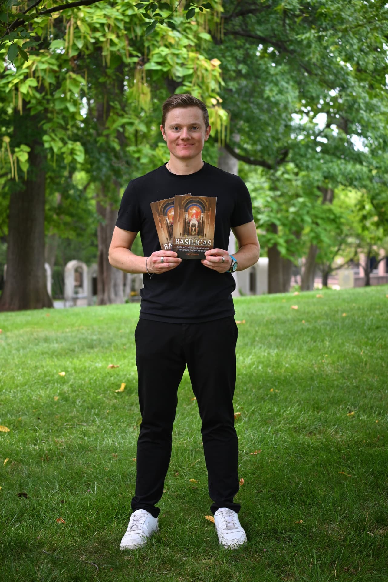Grady J. Connolly holding copies of his book Basilicas
