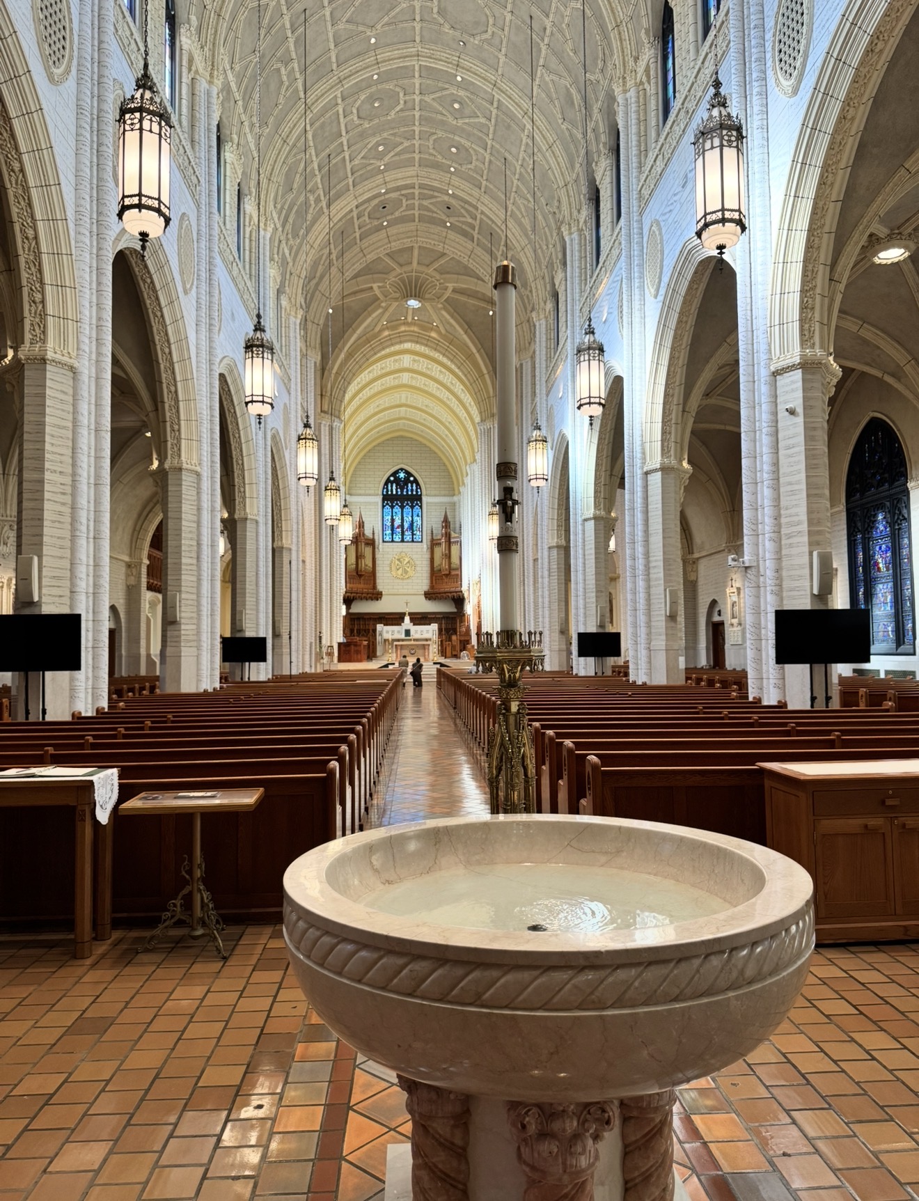 Interior nave and baptismal font of the Basilica of Saints Peter and Paul in Lewiston, Maine
