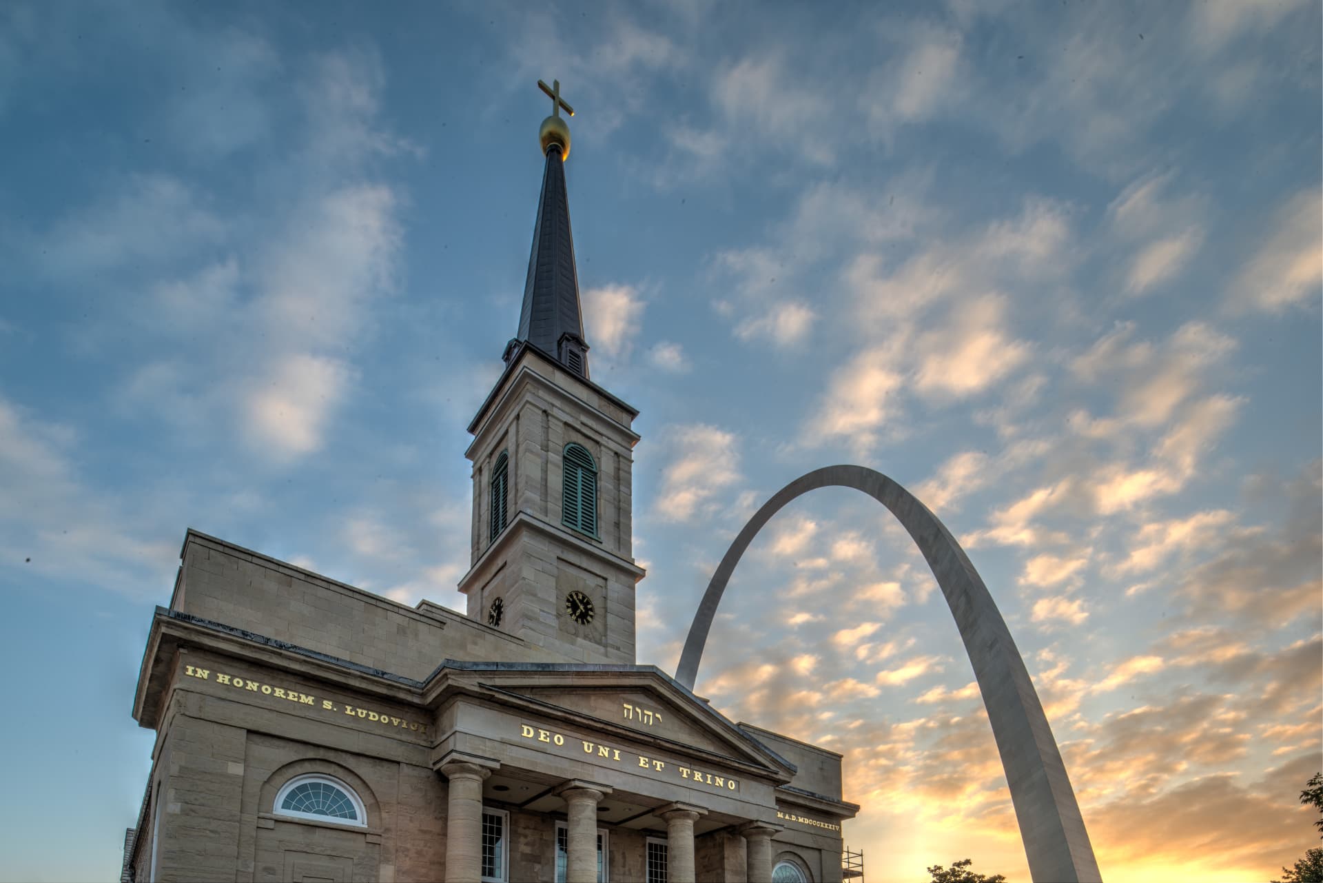 Exterior of the Basilica of Saint Louis, King of France (Old Cathedral) in St. Louis, Missouri, with the Gateway Arch in the background