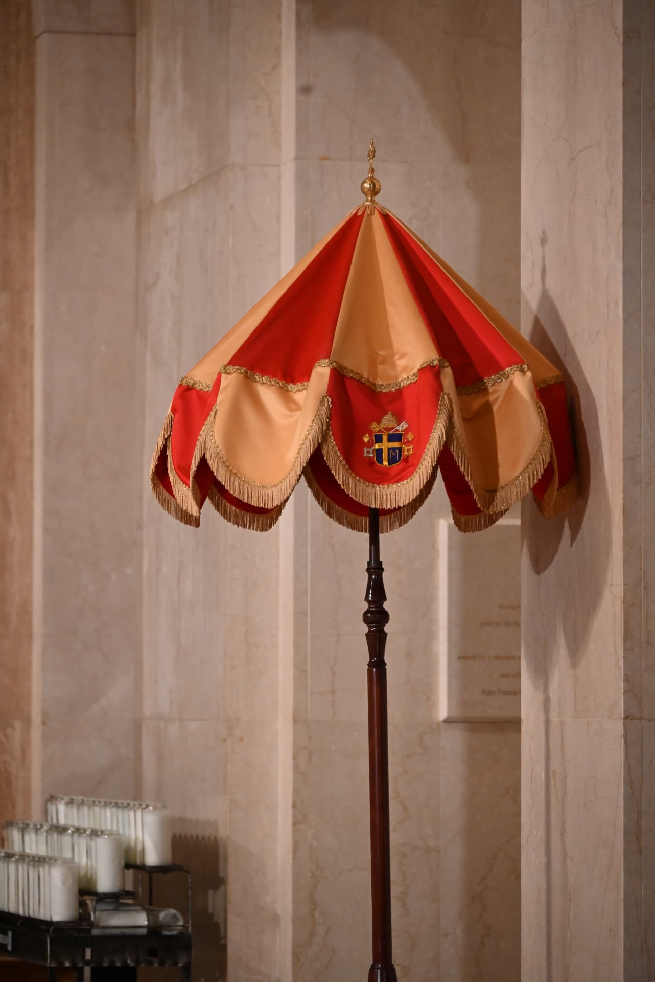 An ombrellino, the red and gold papal canopy displayed inside a basilica