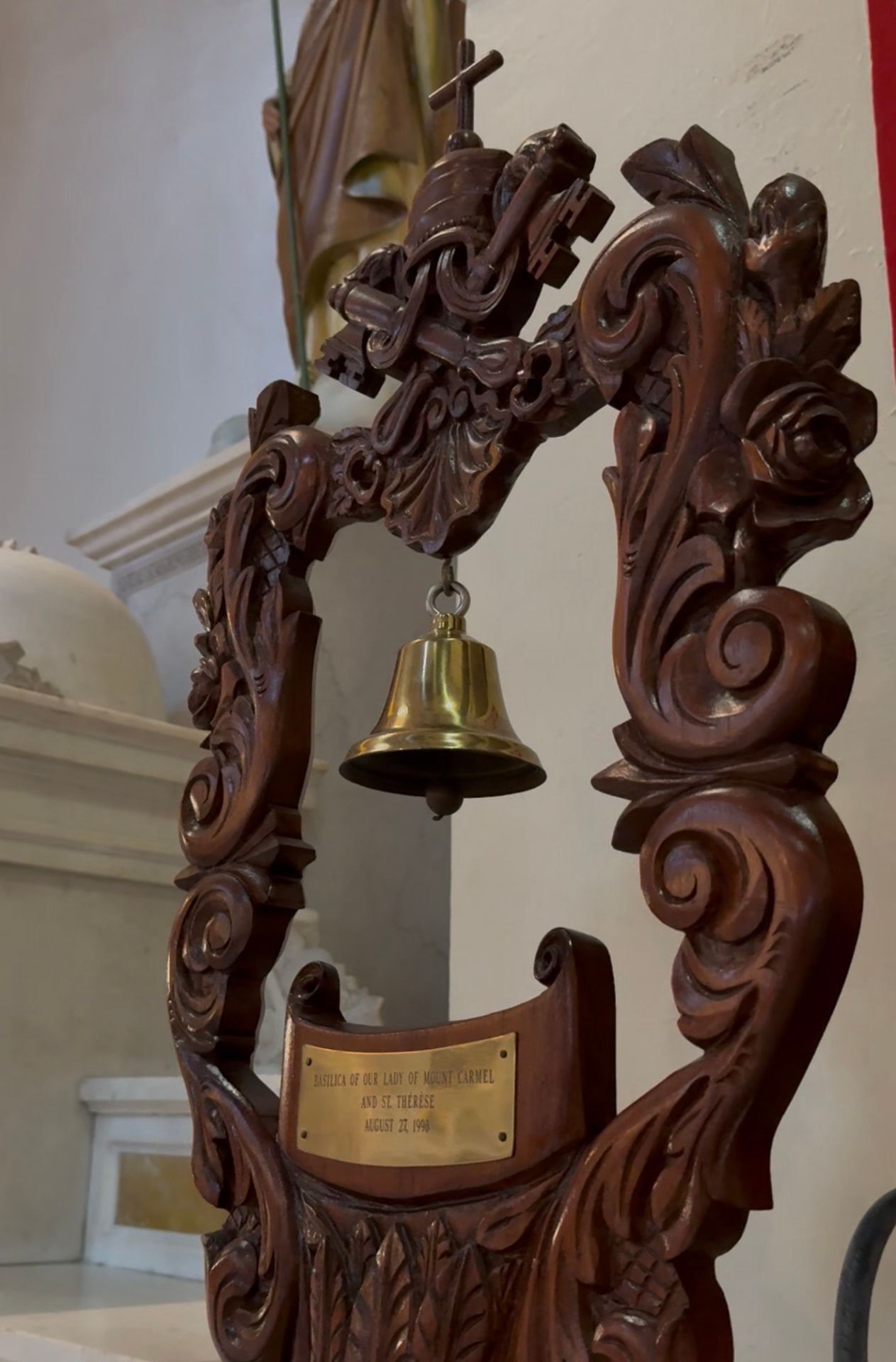 A tintinnabulum, the ceremonial bell mounted on a carved pole in a basilica