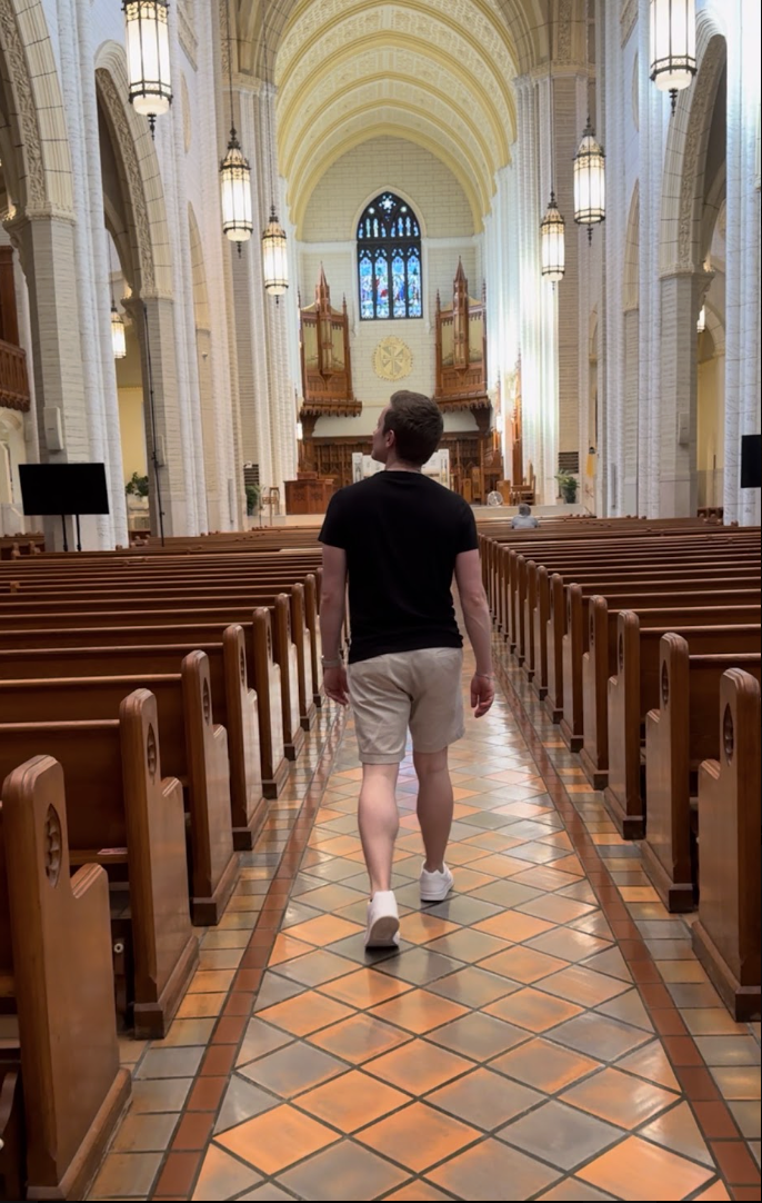 Grady Connolly walking up the center aisle of a basilica