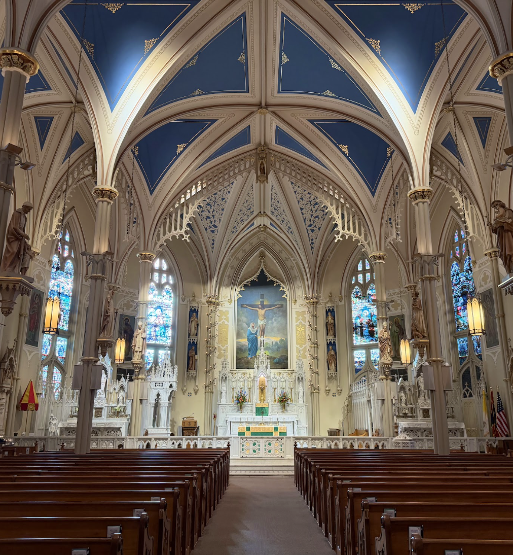 Interior sanctuary of St. Mary Basilica in Natchez, Mississippi with blue vaulted ceiling and stained glass windows